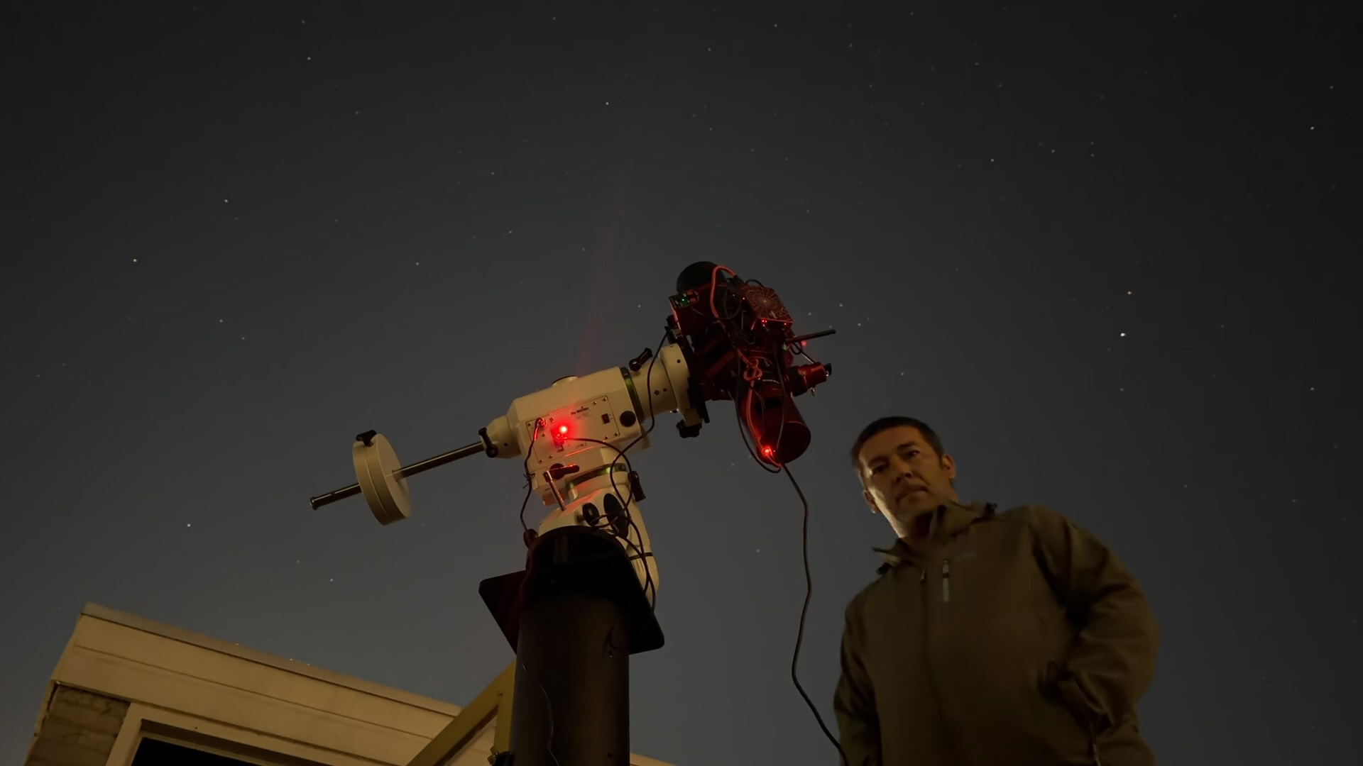 Islam and his telescope beneath the night sky